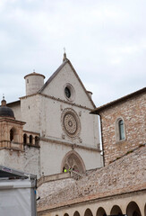 Fototapeta premium Upper Papal Basilica of Saint Francis of Assisi (San Francesco) with the monastery bell tower. Assisi, Perugia, Italy. VERTICAL