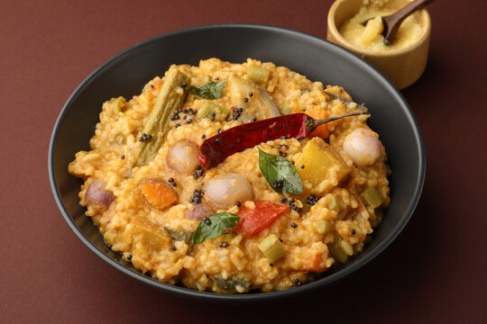 Traditional Tamil Nadu Sambar rice with mixed vegetables, dal, rice, and served with ghee