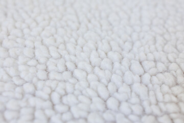 Close up shallow depth of field faux shearling fabric texture soft fluffy textile background © Iryna Miadzvedzeva