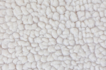 Macro texture of faux shearling fabric soft fluffy textile background for winter fashion and design © Iryna Miadzvedzeva
