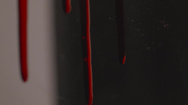 Blood Dripping Horrifyingly Down a Dark Surface Evoking Scary Halloween and Crime Scene Themes