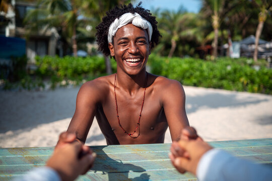 Happy interracial couple embracing and sharing a romantic moment during a tropical island getaway