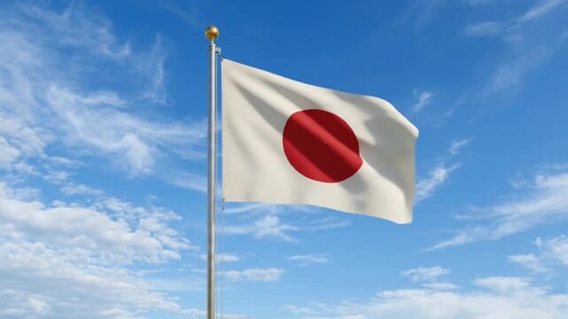 The Japan flag flies against a bright blue sky.