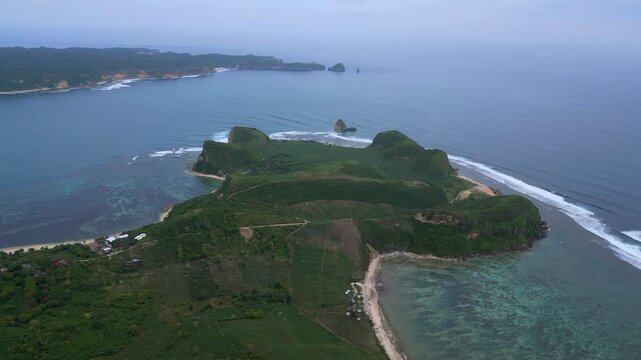 Aerial Coastal Village And Coral Flats,Long Sandy Ribbon Curving Along Shallow Turquoise Shelf, Scattered Houses And Vegetation,Reef Patterns Visible Through Clear Water, Katil beach,Lombok,Indonesia