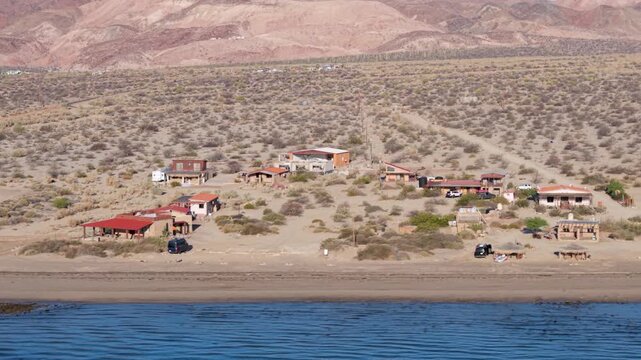 Aerial views capture sunrise over Bahia De Los Angeles. Camping and beach activities take place in Baja California, Mexico.