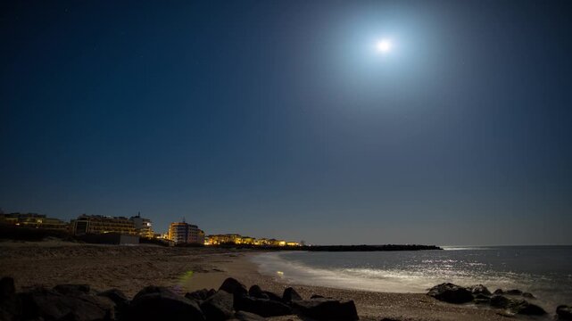 Pomorie town with lights and hotels against the backdrop of the night sky and the Black Sea in Bulgaria