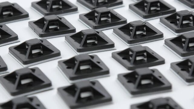 Plastic self-adhesive pad for installing nylon ties.