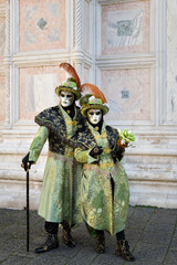 Obraz premium Venice, Italy - February 17, 2026 - People dressed in masks for the Venice Carnival have their photos taken by tourists