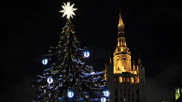 Moscow celebrating Christmas and New Year with illuminated tree and Stalin skyscraper