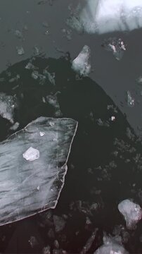 A colossal submarine majestically ascends through the dark, frozen waters of the Arctic Ocean.