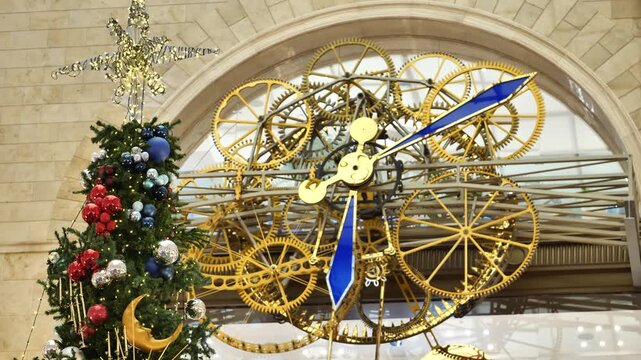 Christmas tree and New Year clock with golden gears in an urban setting