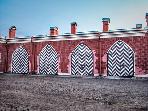 Historic brick facade with patterned arched gates and courtyard