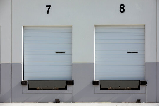 Exterior View of Modern Warehouse Loading Dock Doors
