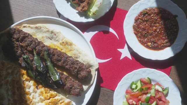 Close-up of Adana kebab menu on the Turkish flag