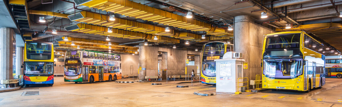Hong Kong, China, 6 March 2026: panoramic view of double decker buses inside Central bus depot with multiple vehicles under industrial ceiling infrastructure