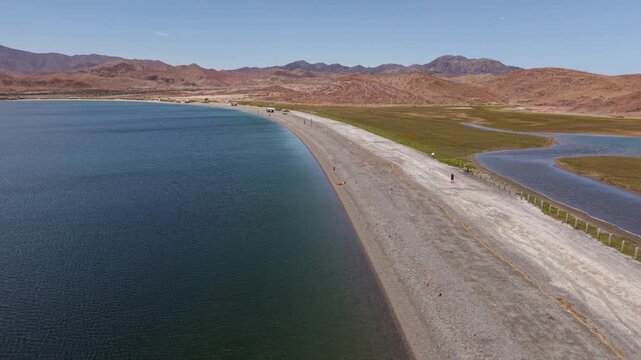 Watch as SUVs and campers gather in La Gringa area by Bahia De Los Angeles along the shore of the Sea of Cortez, Baja California.