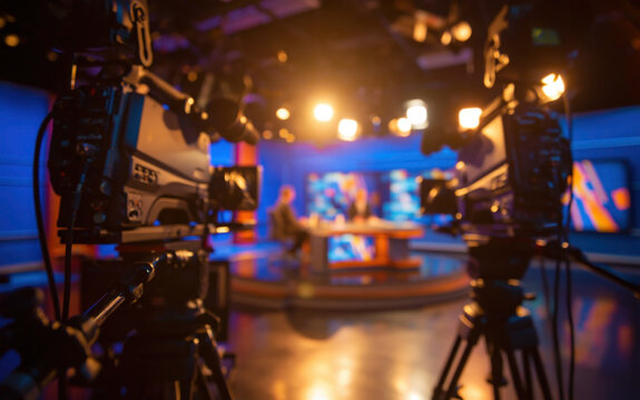 Video cameras filming news broadcast in television studio