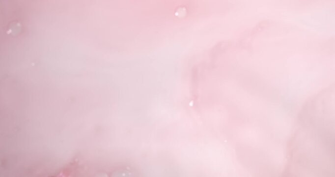 Super Slow Motion Soft Pink Ink Twirls Gracefully In Water Amidst Floating