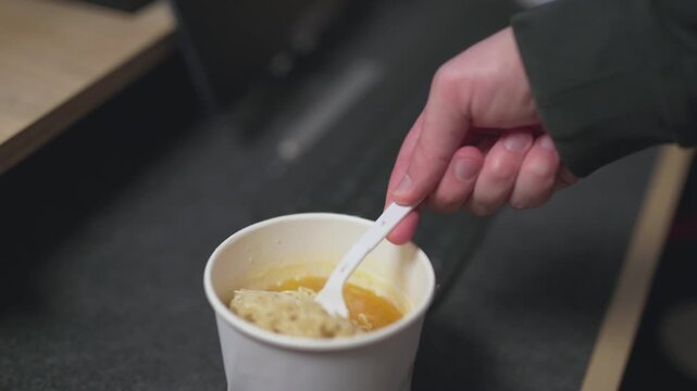 Close-up of pouring hot water into an instant noodle box