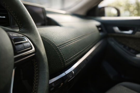 Close-up of luxurious car interior details with green leather
