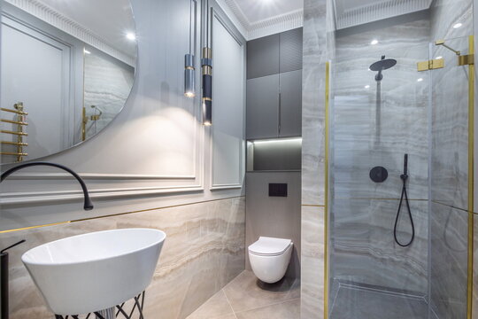 The elegant design of the bathroom with a shower cabin and stylish decor elements.