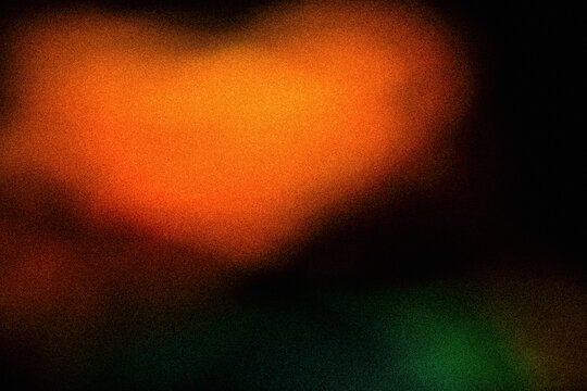 Abstract soft glowing orange and red orb light leak with grainy noise texture