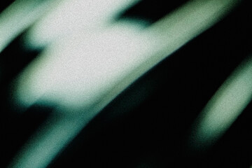 Naklejka premium Blurred bright teal and white diagonal light streaks crossing dark grainy background