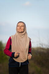 Naklejka premium active muslim woman running outdoors