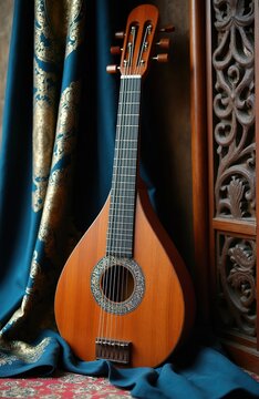 Acoustic dutar stringed instrument leans against ornate blue fabric. Wooden musical tool rests on patterned rug near carved screen. Traditional Eastern culture artifact.