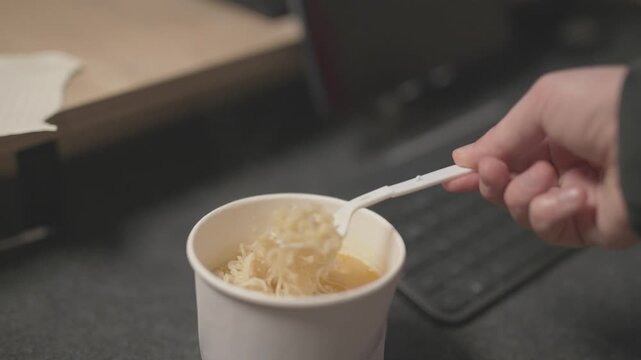 Close-up of pouring hot water into an instant noodle box