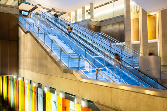 People on moving escalator at Sainte-Anne metro subway station in Rennes - France