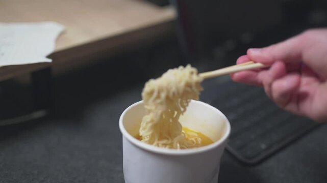 Close-up of pouring hot water into an instant noodle box