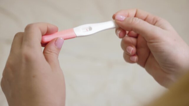 Woman holding in hands pregnancy test. Check quick pregnancy test kit