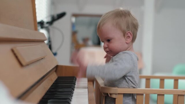 Child discovers melodies. Child eagerly investigates musical sounds and instrument playfulness. Young child delightfully uncovers melodies through playful exploration of musical instruments and notes
