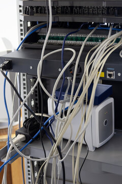Messy Network Server Rack and devices with Tangled Ethernet Cables and Hardware