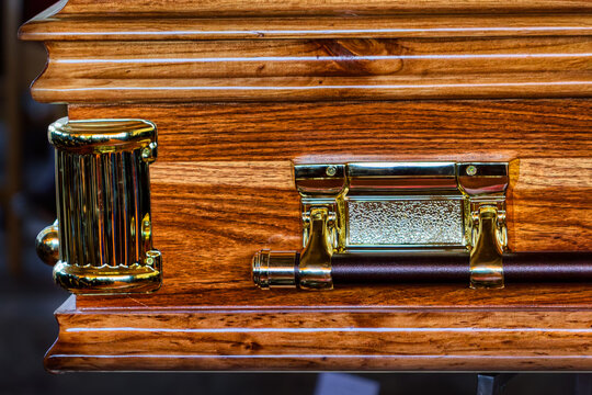 Polished Wood Casket Detail with Ornamental Gold Hardware and Handle  for funeral services.