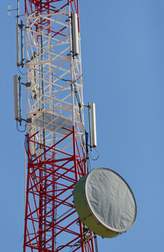 Red and White Telecommunications Tower with Microwave Backhaul Dish Antenna