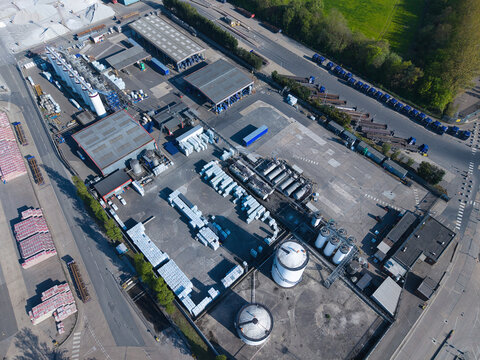 Aerial view of the PD Ports industrial facility with storage tanks, warehouses, and rows of trucks in Scunthorpe, England, United Kingdom.