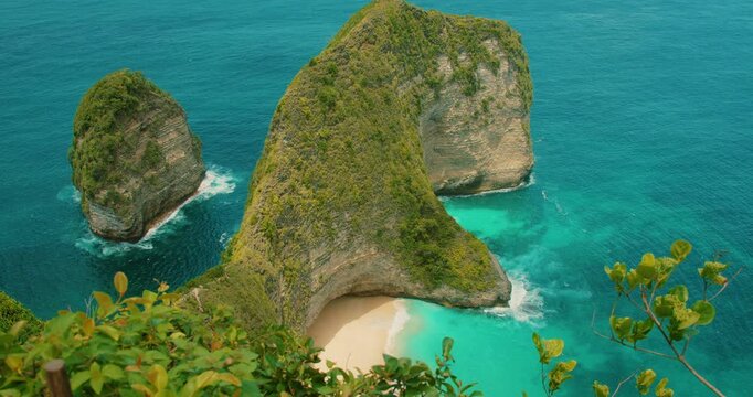 High angle view of tropical coastline with green cliff and turquoise ocean water