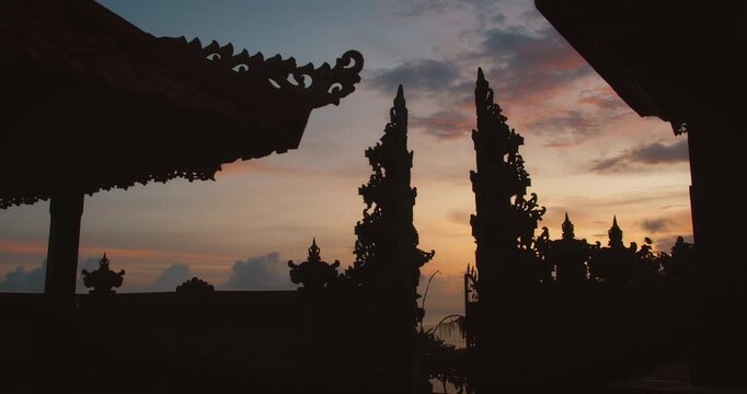 Ornate split stone gateway silhouette under dusk sky in Bali Nusa Penida Indonesia