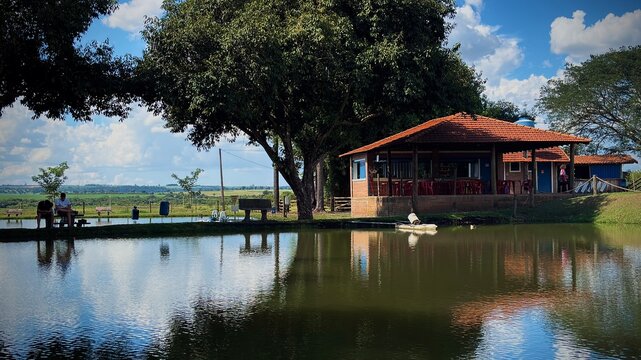 Lakeside house with reflections in rural landscape
