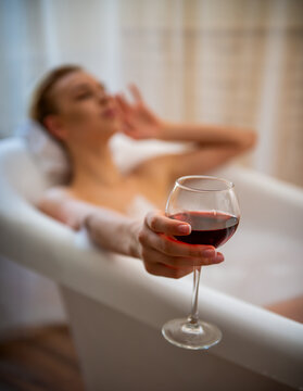 Wine glass in bubble bath.