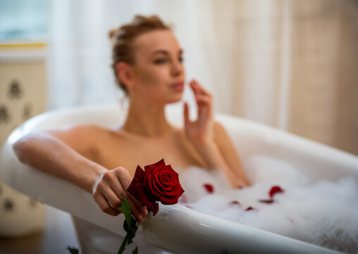 Bubble bath with red rose.