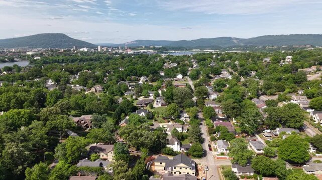 Aerial drone footage of the real estate in North Chattanooga, Tennessee, USA. Tree-lined residential streets, hillside homes, and scenic views near the Tennessee River. 