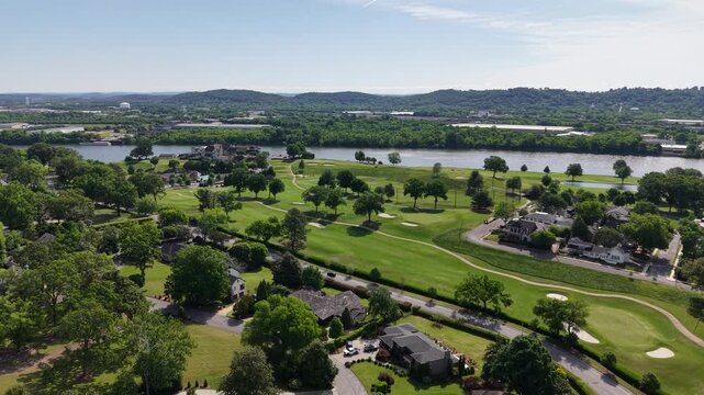 Aerial drone footage of the Riverview neighborhood in North Chattanooga, Tennessee, USA. Tree-lined residential streets, hillside homes, and scenic views near the Tennessee River. 