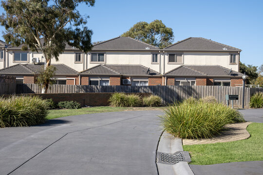 Modern townhouse complex in suburban Melbourne, Australia, featuring double-storey dwellings, native ornamental grasses and shared driveway. Median density housing, real estate and residential homes.