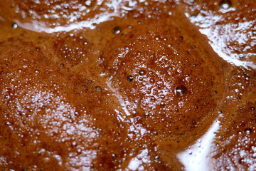 Fototapeta premium Macro shot of mixture of instant coffee with hot water