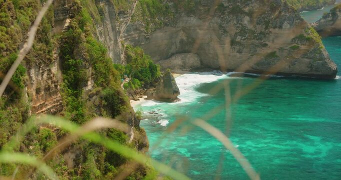 Stunning turquoise ocean water hitting rocky coast of Diamond Beach at Nusa Penida Island Indonesia