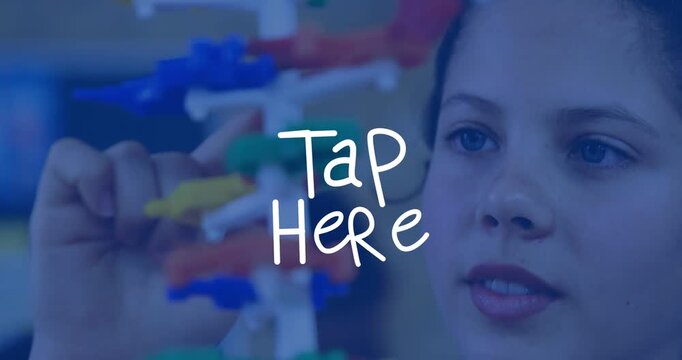 Teen girl tapping toy at Tap Here overlay, adjusting colorful pieces camera revealing face in lab