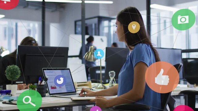 Woman typing laptop, colleague passing starting social-media icons growing over desk showing chart